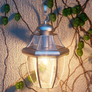 A unique Colonial Outdoor Wall Light, 14"H x 8"W, from the Cambridge Collection hanging on a wall.