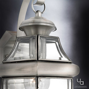 A beautiful outdoor lighting fixture from the Cambridge Collection, the UQL1143 Colonial Outdoor Wall Light offers an urban ambiance and features a clear glass shade with an aged silver finish.