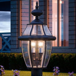 A unique lighting fixture, the Urban Ambiance UQL1150 Colonial Outdoor Post Light, 23"H x 12.5"W, adds an urban ambiance in front of a house.