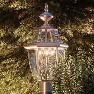 A unique Urban Ambiance Colonial Outdoor Post Light, 23"H x 12.5"W, with a tree in the background.