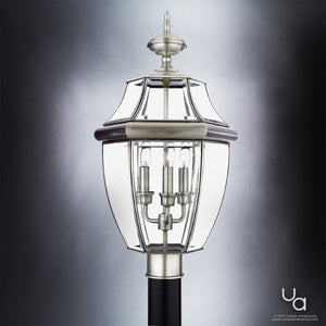 A luxury outdoor post light with a unique design, featuring an aged silver finish and clear glass shade.