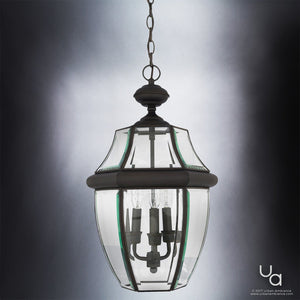 Showcasing the Urban Ambiance UQL1159 Colonial Outdoor Pendant Light from the Cambridge Collection, this hanging lantern-style fixture features a black silk-finished metal frame with clear beveled glass panels and four candle-shaped bulbs, displayed against a neutral background.