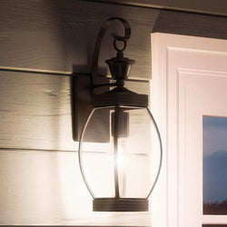 An UQL1170 Colonial Outdoor Wall Light with a glass shade, lamp.