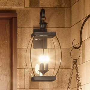 A beautiful and unique lighting fixture, the Urban Ambiance UQL1172 Colonial Outdoor Wall Light, 22.5"H x 9"W, with a Medieval Bronze Finish from the Manchester