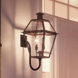 An Urban Ambiance UQL1210 Luxury Historic Outdoor Wall Light, 23.5"H x 10.5"W, Rustic Copper Finish from the Paris Collection with a lantern hanging on it