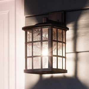 An Urban Ambiance UQL1231 Craftsman Outdoor Wall Light, 10.5"H x 6.5"W, Parisian Bronze Finish, Zurich Collection lamp on the side of a house