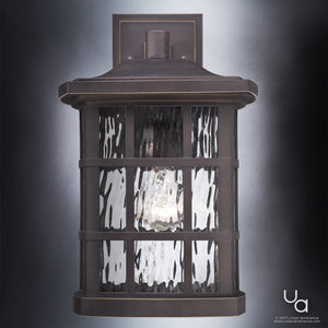 Introducing the UQL1235 Craftsman Outdoor Wall Light from the Zurich Collection by Urban Ambiance—this 15.5″H x 9.5″W wall sconce features a durable marine-grade construction, weather-resistant design, and elegant Parisian Bronze finish with clear textured glass panels, all mounted on a flat rectangular backplate.