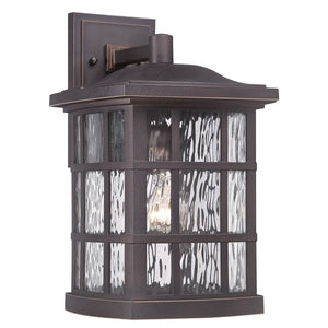 The Urban Ambiance UQL1235 Craftsman Outdoor Wall Light from the Zurich Collection features a Parisian Bronze finish and textured glass panels, enclosing a single light bulb. With its marine-grade construction, this 15.5″H x 9.5″W weather-resistant wall sconce combines style and durability for your exterior spaces.