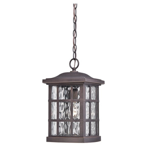 The Urban Ambiance UQL1251 Craftsman Outdoor Pendant Light from the Zurich Collection features a Parisian Bronze finish, water glass diffuser panels, and a chain for mounting. Shown unlit against a white background, this 15″ high by 9.5″ wide marine-grade outdoor pendant light brings timeless charm and durability to any exterior décor.