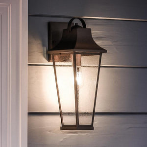 A gorgeous Urban Ambiance UQL1282 Tudor Outdoor Wall Light, 19.25"H x 7.25"W, Black Sand Finish, Constanta Collection on the side of a house