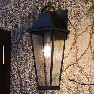 A beautiful Tudor Outdoor Wall Lamp from Urban Ambiance on a brick wall.