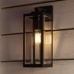 A unique UQL1331 Farmhouse Outdoor Wall Light, 17"H x 6"W, with a beautiful Black Finish from the Quincy Collection by Urban Ambiance on the side of a house.