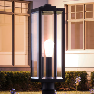 A beautiful Urban Ambiance UQL1333 Farmhouse Outdoor Post/Pier Light, showcasing a unique black finish, enhances the luxury of the Quincy Collection in front of a house.