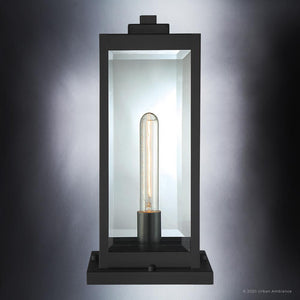 The Urban Ambiance UQL1336 Modern Farmhouse Outdoor Pier Light from the Quincy Collection features a rectangular design in a natural black finish, clear glass panels, and a central exposed tubular bulb, shown against a gradient background.