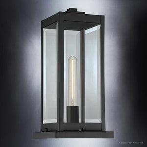 The Urban Ambiance UQL1336 Modern Farmhouse Outdoor Pier Light from the Quincy Collection features a natural black finish and clear glass panels enclosing a vertical tubular bulb, showcased here illuminated against a gradient gray background. This rectangular fixture measures 16″ high by 7.5″ wide.
