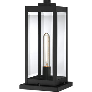 Experience the Urban Ambiance UQL1336 Modern Farmhouse Outdoor Pier Light from the Quincy Collection, featuring a sleek natural black metal and glass lantern design with an exposed vertical bulb inside—perfect for adding contemporary farmhouse charm to your space. Measures 16″H x 7.5″W.