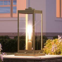 An Urban Ambiance UQL1346 Modern Farmhouse Outdoor Pier Light, 16"H x 7.5"W, Antique Brass Finish, Quincy Collection with a gorgeous light on it.