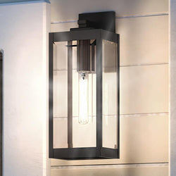 A beautiful UQL1350 Modern Farmhouse Outdoor Wall Light, 14.25"H x 5"W, Estate Bronze Finish, Quincy Collection by Urban Ambiance on a white wall.