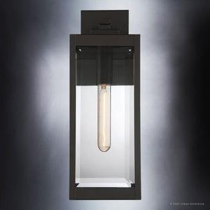 The UQL1351 Modern Farmhouse Outdoor Wall Light from the Quincy Collection by Urban Ambiance features a rectangular estate bronze-finished metal and glass design with an exposed vertical filament bulb, illuminated against a gradient gray background to highlight its perfect blend of modern farmhouse style and versatile outdoor wall sconce functionality.