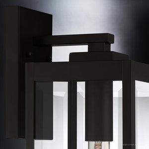 Close-up of the Urban Ambiance UQL1351 Modern Farmhouse Outdoor Wall Light from the Quincy Collection, featuring a rectangular metal frame and clear glass panels in an Estate Bronze finish, measuring 17″ high by 6″ wide. This elegant wall sconce is the perfect addition to any modern farmhouse lighting design.