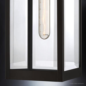 Close-up of the Urban Ambiance UQL1351 Modern Farmhouse Outdoor Wall Light from the Quincy Collection, featuring a visible vertical filament bulb inside its modern glass and metal design, and finished in Estate Bronze for a look that perfectly complements modern farmhouse exteriors.