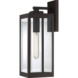 The UQL1351 Modern Farmhouse Outdoor Wall Light from Urban Ambiance’s Quincy Collection features a rectangular design with a vertical bulb, finished in estate bronze and mounted on a square backplate, providing contemporary exterior lighting for any space.