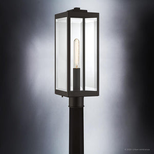 Elevate your exterior spaces with the Urban Ambiance UQL1353 Modern Farmhouse Outdoor Post/Pier Light from the Quincy Collection. Featuring a striking rectangular glass and metal enclosure in an Estate Bronze finish, this 20.5″ tall fixture showcases a visible vertical bulb inside, seamlessly blending contemporary design with inviting modern farmhouse appeal.