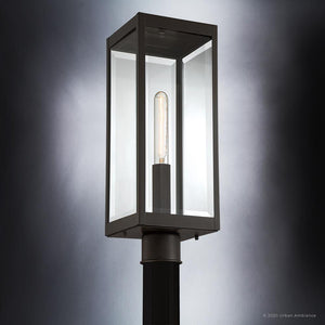 The UQL1353 Modern Farmhouse Outdoor Post/Pier Light from the Quincy Collection by Urban Ambiance features a 20.5″ tall rectangular enclosure crafted with clear, beveled glass and an estate bronze finish, elegantly displaying an exposed vertical bulb—making it a perfect option for modern farmhouse outdoor lighting.