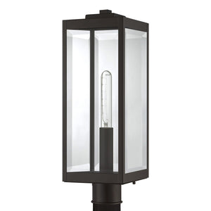 The UQL1353 Modern Farmhouse Outdoor Post/Pier Light from Urban Ambiance’s Quincy Collection features clear beveled glass panels and a visible vertical bulb within a sleek estate bronze-finished frame—an ideal way to bring modern farmhouse outdoor lighting style to your space. Measures 20.5” high by 7” wide.