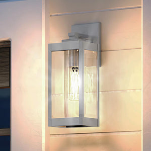 A beautiful Urban Ambiance UQL1360 Modern Farmhouse Outdoor Wall Light, 14.25"H x 5"W, Stainless Steel Finish, Quincy Collection on the side of a house