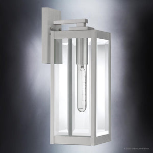 The Urban Ambiance UQL1361 Modern Farmhouse Outdoor Wall Light from the Quincy Collection features a sleek rectangular design with a stainless steel finish, clear glass panels, and an exposed tubular bulb mounted on a vertical backplate; measures 17″ high by 6″ wide.