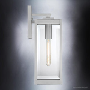 The Urban Ambiance UQL1361 Modern Farmhouse Outdoor Wall Light from the Quincy Collection features a sleek rectangular design in a stainless steel finish with an exposed tubular bulb, shown against a gradient gray background.