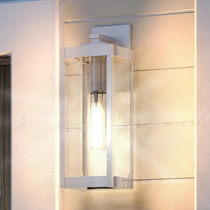 A beautiful UQL1361 Modern Farmhouse Outdoor Wall Light, 17"H x 6"W, Stainless Steel Finish, Quincy Collection by Urban Ambiance on the side of a house.