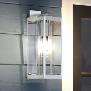 A unique and gorgeous Urban Ambiance UQL1362 Modern Farmhouse Outdoor Wall Light, 20"H x 7"W, Stainless Steel Finish, Quincy Collection on the side of a house.