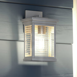 A unique modern lighting fixture, UQL1393, is displayed on the side of a wall.
