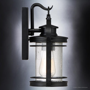 Urban Ambiance’s UQL1430 Nautical Outdoor Wall Light from the Cannes Collection features a Black Silk finish and clear cylindrical glass shade with visible bulb, mounted on a rectangular backplate; this 11.5″H x 6.75″W vintage-inspired lantern brings timeless elegance to your exterior décor.