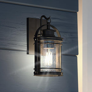A unique and beautiful UQL1430 Nautical outdoor wall light, 11.5"H x 6.75"W, in a Black Silk Finish from Urban Ambiance on a blue wall.