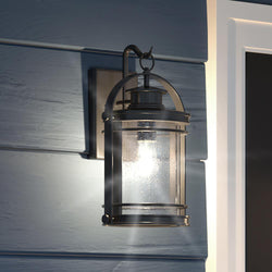 A unique and gorgeous Urban Ambiance UQL1431 Nautical Outdoor Wall Light, 15"H x 9"W, Black Silk Finish, from the Cannes Collection on the side of a