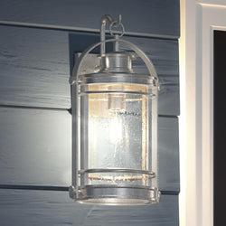 A unique Nautical Outdoor Wall Light, 18.25"H x 10.75"W, with an Urban Aluminum Finish, from the Cannes Collection, on the side of a house.