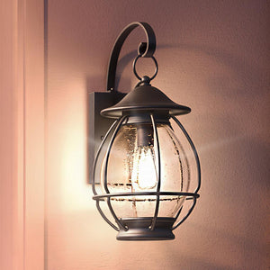 A beautiful Craftsman outdoor wall light with a lantern hanging on the wall.