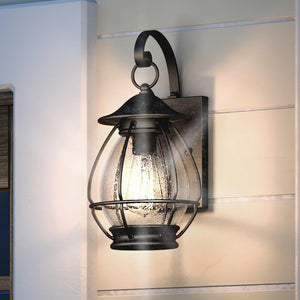 A gorgeous UQL1473 Craftsman Outdoor Wall Light, 14"H x 7"W, in a Black Sand Finish from the Hammond Collection by Urban Ambiance installed on the wall of a house