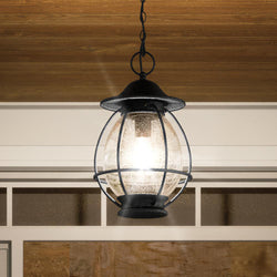 A beautiful Craftsman Outdoor Pendant Light from the Hammond Collection by Urban Ambiance hanging from a wooden ceiling.