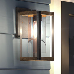 A gorgeous Urban Ambiance UQL1503 Modern Outdoor Wall Light, 13.25"H x 6.75"W, Antique Black Finish, Suffolk Collection on a wall next to a