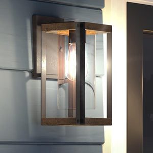 A gorgeous Urban Ambiance UQL1503 Modern Outdoor Wall Light, 13.25"H x 6.75"W, Antique Black Finish, Suffolk Collection on a wall next to a