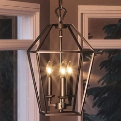 A beautiful lighting fixture, the Urban Ambiance Colonial Chandelier, 17"H x 9.5"W, with a Parisian Bronze Finish, enhances the luxury of the living room when hanging over