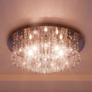 Featuring a polished chrome finish, the Urban Ambiance UQL2081 Traditional Flush Mount Ceiling Light from the Manhattan Collection showcases a round, ceiling-mounted design with hanging glass or crystal beads. Measuring 9 inches high by 19.75 inches wide, this modern flush mount is illuminated by multiple exposed bulbs that cast a warm glow onto the ceiling.