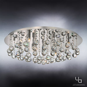 The Urban Ambiance UQL2081 Traditional Flush Mount Ceiling Light from the Manhattan Collection features a polished chrome finish base and multiple hanging crystal spheres, creating a cascading effect. Measuring 9 inches high by 19.75 inches wide, this ceiling fixture elegantly displays some visible bulbs among the shimmering crystal strands, highlighting its refined design.