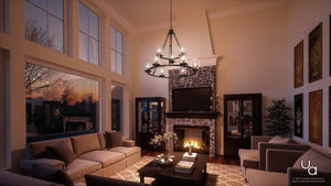 Modern living room featuring high ceilings, expansive windows, comfortable sofas, a coffee table, fireplace with a TV above, bookshelves, and warm sunset lighting. Overhead, the Urban Ambiance UQL2131 Industrial Chandelier from the Valencia Collection (30″H x 33″W) in an Estate Bronze Finish casts a sophisticated glow that enhances the inviting atmosphere.