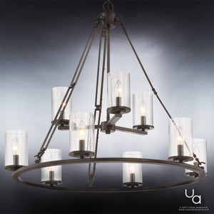 The Urban Ambiance UQL2131 Industrial Chandelier from the Valencia Collection features eight lights with clear seeded glass cylindrical shades and a circular metal frame in an Estate Bronze finish, suspended by metal rods against a gradient gray background—an elegant interpretation of industrial chandelier style.
