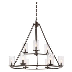 The Urban Ambiance UQL2131 Industrial Chandelier from the Valencia Collection features an estate bronze finish and a two-tiered design, with cylindrical seeded glass shades housing candle-style bulbs, and hangs from a chain. The fixture measures 30 inches high by 33 inches wide.